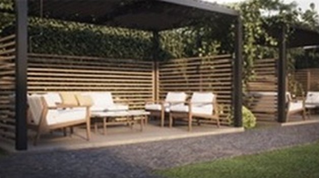Courtyard pergolas with cushioned lounge seating, wood slat screens and greenery