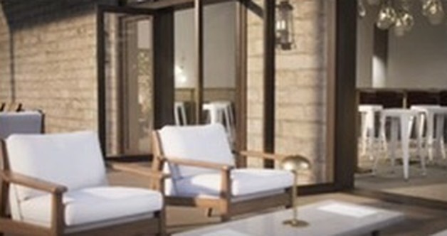 Outdoor table with white-cushioned armchairs on the patio outside the tasting room
